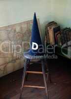 Old dunce cap on stool