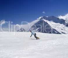 Snowboarder descends a slope