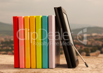 Row of colorful books with electronic book reader