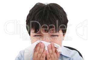 sick boy blowing his nose, white background