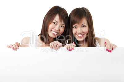 Oriental girls with blank sign