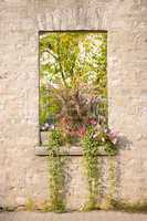 Rustic Stone Window with Flowers in Flowerbox