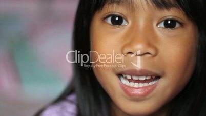 Little Girl Wiggling Her Loose Front Tooth