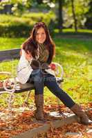 Autumn attractive woman eat apple sunset park