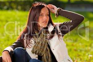 Autumn sunset park woman sitting on bench