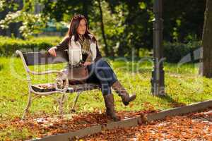 Autumn beautiful woman sit on bench park