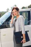 Elegant businesswoman stand by luxury car calling