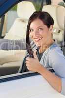 Attractive businesswoman in luxury car thumb-up