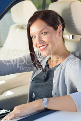 Attractive businesswoman drive luxury car smiling
