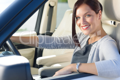 Attractive businesswoman drive luxury car smiling