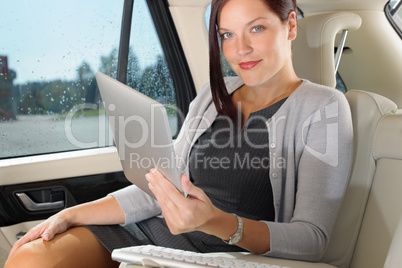 Executive businesswoman in car work touch tablet