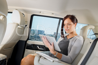 Executive businesswoman in car work touch tablet