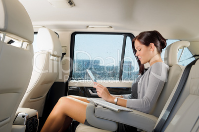 Executive businesswoman in car work touch tablet