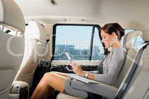 Executive businesswoman in car work touch tablet