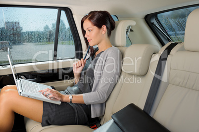 Executive businesswoman work laptop car backseat