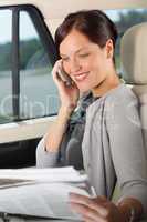Executive woman manager sitting in car calling