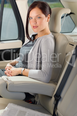 Executive woman manager sitting in car backseat