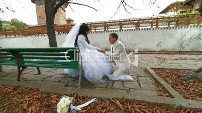 Newlyweds on  bench in autumn park