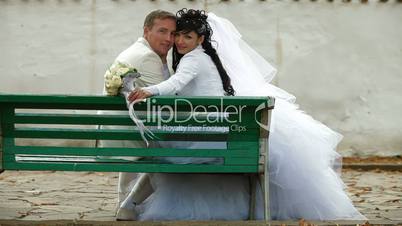 just married couple sitting  in autumn park