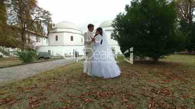 just married Crimean Tatar couple posing against mosque