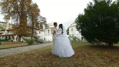 just married Crimean Tatar couple posing against mosque