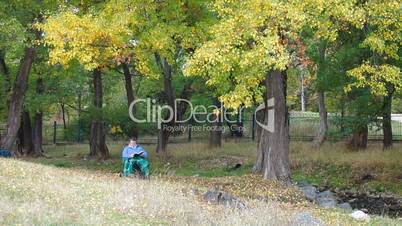 Senior Woman Reading in Park