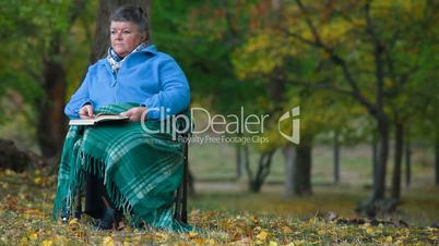 Senior woman reading outdoors