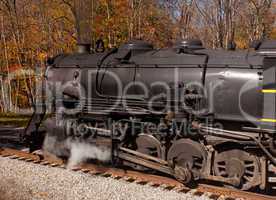 Steam train powers along railway