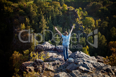 young man standing on a rock slope