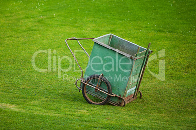 truck to collect the grass on the background of green grass
