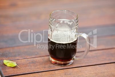 mug with dark beer standing on the table