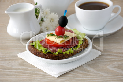 Sandwich with a cup of coffee and milk