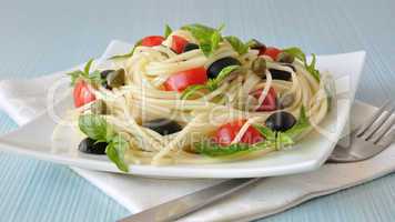 Spaghetti with tomato, capers and basil with olives
