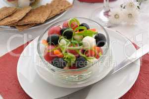 Salad of lettuce, cherry tomatoes, olives and mozzarella with pe