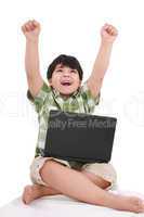 Happy little boy with laptop with moving apart his hands - indoo