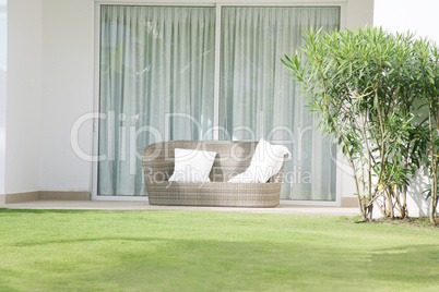 A large chair cushion in front of a large open window