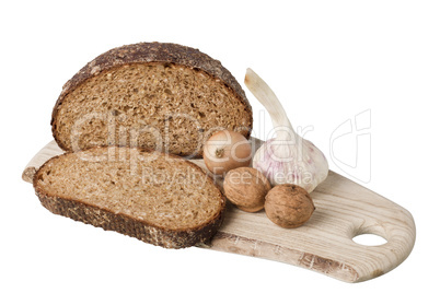 brown bread on shelf with onion, garlic and walnut