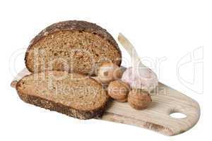 brown bread on shelf with onion, garlic and walnut