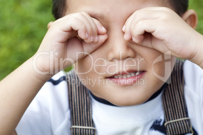 Boy covering eyes