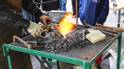 blacksmith takes metal rings