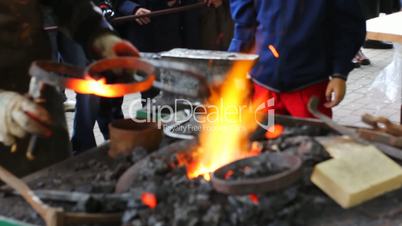 blacksmith puts two hot metal rings