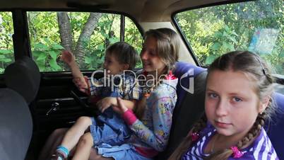 two sisters and brother in car