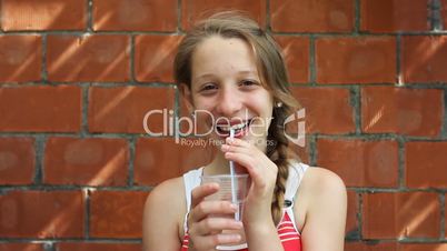 young girl sits and drinks