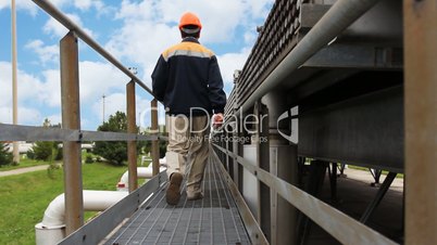 engineer goes away on long metal corridor