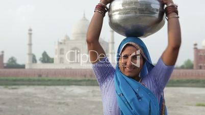 Indian Woman wearing Sari in front of Taj Mahal