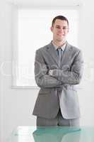 Business man with his arms folded and smiling