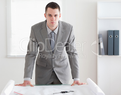 Architect standing behind a table Architect standing behind a table