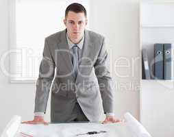 Architect standing behind a table