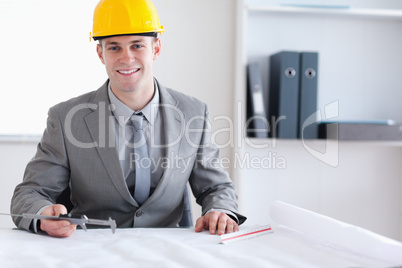 Smiling architect working on a plan