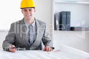 Smiling architect working on a plan
